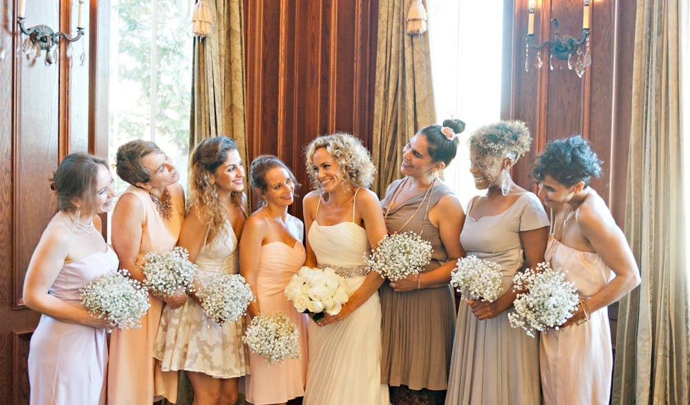 Bride and Bridesmaids Holding Flowers During Reception