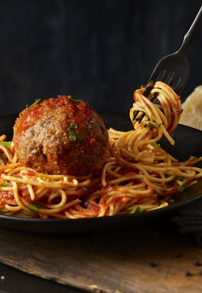 Fork Picking up Spaghetti on Plate with Meatball and Sauce